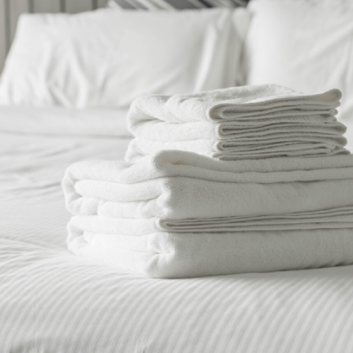 White towel on bed decoration in bedroom interior